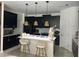 Modern kitchen with island, stainless steel appliances, and dark cabinetry at 1767 Bee Nice Dr, Kissimmee, FL 34744