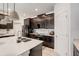 Modern kitchen with dark wood cabinets, stainless steel appliances, and an island with a sink at 1767 Bee Nice Dr, Kissimmee, FL 34744