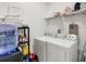 Bright laundry room with shelving and a water dispenser at 1767 Bee Nice Dr, Kissimmee, FL 34744
