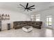 Living room with a sectional sofa, coffee table, and ceiling fan at 1767 Bee Nice Dr, Kissimmee, FL 34744