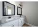 Double vanity bathroom with granite countertops, white cabinetry, and modern fixtures at 7849 Somersworth Dr, Kissimmee, FL 34747