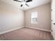 Cozy bedroom with plush carpeting, neutral walls, and natural light at 7849 Somersworth Dr, Kissimmee, FL 34747