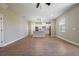 Open-concept living room and kitchen area with wood-look flooring and neutral-toned walls at 7849 Somersworth Dr, Kissimmee, FL 34747