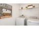 Laundry room with washer, dryer, and overhead storage shelf at 4430 Petunia St, Lake Hamilton, FL 33851