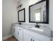 Double vanity bathroom with granite countertop, modern fixtures, and framed mirrors at 7757 Somersworth Dr, Kissimmee, FL 34747