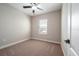 Cozy bedroom with neutral carpet and ample natural light from the window at 7757 Somersworth Dr, Kissimmee, FL 34747
