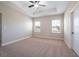 Spacious bedroom with plush carpeting, neutral-toned walls, and two large windows at 7853 Somersworth Dr, Kissimmee, FL 34747