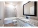 Well-appointed bathroom with a granite countertop vanity, a bathtub, and tiled flooring at 7865 Somersworth Dr, Kissimmee, FL 34747