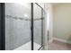 Modern bathroom with a glass-enclosed shower and tiled walls at 7865 Somersworth Dr, Kissimmee, FL 34747
