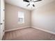 A cozy bedroom with neutral-colored carpeting and a large window at 7865 Somersworth Dr, Kissimmee, FL 34747
