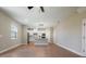 Open-concept living area with wood-look flooring and a view of the kitchen at 7865 Somersworth Dr, Kissimmee, FL 34747