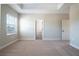 Spacious main bedroom with plush carpeting and an ensuite bathroom at 7865 Somersworth Dr, Kissimmee, FL 34747