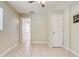 Large bedroom with tile floors and access to hallway at 718 Kensington St, Eustis, FL 32726