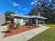 Close-up view of the front exterior showcasing the home's entrance and landscaping at 7598 W C 48, Bushnell, FL 33513