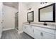 Modern bathroom with dual vanities, granite countertops, and a walk-in shower at 7752 Somersworth Dr, Kissimmee, FL 34747