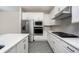 Modern kitchen with white cabinets, stainless steel appliances, and quartz countertops at 7752 Somersworth Dr, Kissimmee, FL 34747