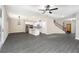 Open concept living and dining area with wood-look flooring and a view of the kitchen at 7752 Somersworth Dr, Kissimmee, FL 34747