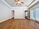 Living room with wood floors, ceiling fan, and arched doorways at 1004 Ashton Woods Ln, Lakeland, FL 33813