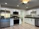 Bright kitchen with stainless steel appliances and light wood flooring at 17729 Se 114Th Ct, Summerfield, FL 34491