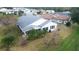 Aerial view of home with gray roof, enclosed patio, and landscaped yard at 1926 Long Boat Dr, Lakeland, FL 33810