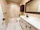 Clean and functional bathroom with tiled shower, white vanity, and tile flooring at 1926 Long Boat Dr, Lakeland, FL 33810