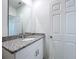 Bathroom with granite countertop and white cabinets at 4407 Rapallo Ave, Winter Haven, FL 33884