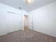 Well-lit bedroom with carpet flooring and access to a bathroom at 4407 Rapallo Ave, Winter Haven, FL 33884