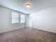 Spacious bedroom with carpet, two windows and a door at 4407 Rapallo Ave, Winter Haven, FL 33884