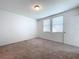 Spacious bedroom with neutral carpeting and two windows at 4407 Rapallo Ave, Winter Haven, FL 33884
