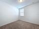 Bedroom with carpet flooring and window with blinds at 4407 Rapallo Ave, Winter Haven, FL 33884