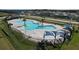 Aerial view of community pool with surrounding landscaping and cabanas at 4407 Rapallo Ave, Winter Haven, FL 33884