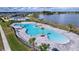 Community pool with a unique design near a lake at 4407 Rapallo Ave, Winter Haven, FL 33884