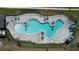 An overhead view of the community pool with a unique design and plenty of space for lounging at 4407 Rapallo Ave, Winter Haven, FL 33884