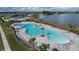 Aerial view of resort-style community pool with palm trees and lounge area at 4407 Rapallo Ave, Winter Haven, FL 33884