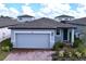 Gray house with paver driveway and landscaping; two-car garage at 4407 Rapallo Ave, Winter Haven, FL 33884