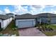 One-story home with gray exterior, paver driveway, and neat landscaping at 4407 Rapallo Ave, Winter Haven, FL 33884