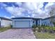 Newly constructed home with gray exterior, paver driveway, and landscaped front yard at 4407 Rapallo Ave, Winter Haven, FL 33884
