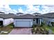 One-story home with gray exterior, paver driveway, and neat landscaping at 4407 Rapallo Ave, Winter Haven, FL 33884