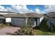 Modern single-Gathering home with gray garage door and brick paver driveway at 4407 Rapallo Ave, Winter Haven, FL 33884