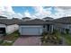 Modern single-Gathering home with gray garage door and brick paver driveway at 4407 Rapallo Ave, Winter Haven, FL 33884