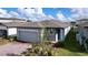 One-story home with gray exterior, paver driveway, and neat landscaping at 4407 Rapallo Ave, Winter Haven, FL 33884