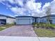 One-story home with gray exterior, two-car garage, and landscaped front yard at 4407 Rapallo Ave, Winter Haven, FL 33884
