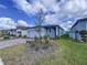 One-story home with gray exterior, two-car garage, and landscaped side yard at 4407 Rapallo Ave, Winter Haven, FL 33884