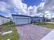 Home's exterior features a paved driveway and landscaping at 4407 Rapallo Ave, Winter Haven, FL 33884