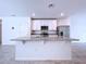 Granite kitchen island with white cabinets and stainless steel appliances at 4407 Rapallo Ave, Winter Haven, FL 33884