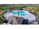 Aerial view of a community pool with lounge chairs, a playground, and a shaded area at 4936 Mainsail Street, Haines City, FL 33844