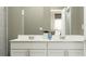 Modern bathroom featuring dual vanities, white cabinets, and a sleek countertop at 7005 Rosy Sky Ave, Orlando, FL 32829