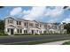 Attractive row of townhomes with covered entries and landscaped yards at 7005 Rosy Sky Ave, Orlando, FL 32829
