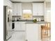 Bright kitchen features white shaker cabinets, stainless steel appliances, and an island at 7005 Rosy Sky Ave, Orlando, FL 32829