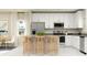 Modern kitchen with white cabinets, stainless steel appliances, and an island with seating at 7005 Rosy Sky Ave, Orlando, FL 32829